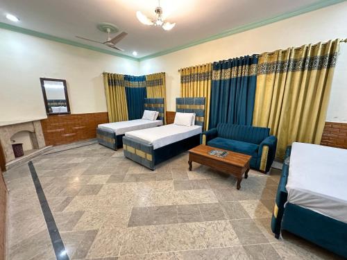 伊斯兰堡Decent Lodge Guest House F-11的酒店客房,设有两张床和一张沙发