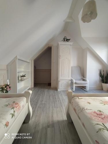 克罗奇琴科Willa Grono的阁楼卧室配有两张床和椅子