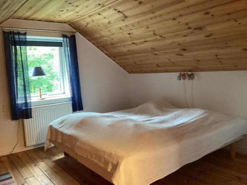 穆塔拉Holiday home MOTALA VI的卧室内的一张床铺,设有木制天花板