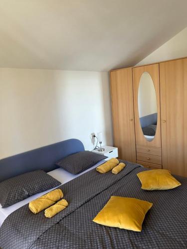 奥帕提亚Kuća za odmor Viktoria的一间卧室配有两张带黄色枕头的床