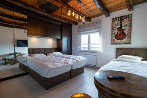 萨格勒布Arena Rooms Zagreb的卧室配有两张床,墙上配有吉他