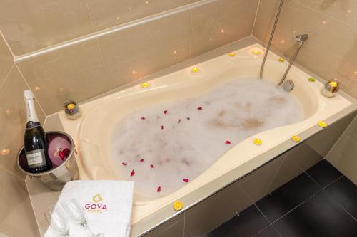 哈恩GOYA HOTEL的装满血的浴缸和一瓶葡萄酒