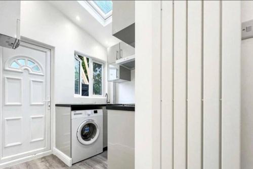 奇斯尔赫斯特Studio apartment/flat的一间白色的厨房,配有洗衣机和门