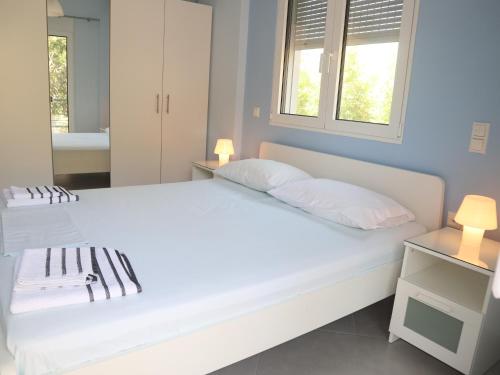 苏尼翁Patroclos SeaView的卧室配有一张带两个枕头的大白色床