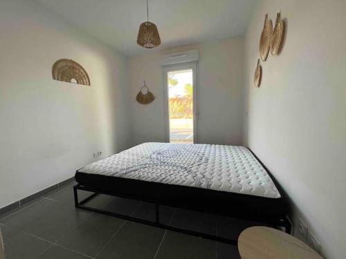贝济耶App Le Golf T3 terrasse wifi pkg的卧室位于客房的角落,配有一张床