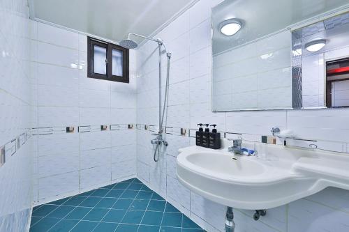 首尔Picasso Motel的白色的浴室设有水槽和镜子
