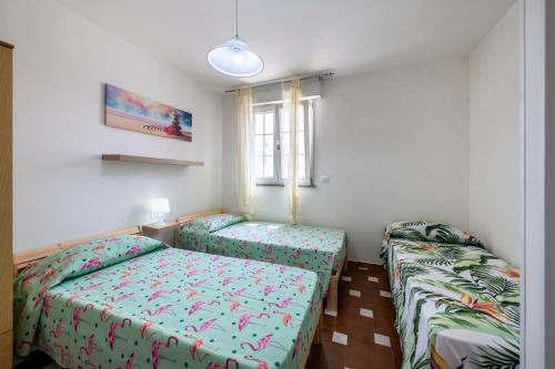 佩斯科勒海滨Casa vacanze Pescoluse的一间卧室设有两张床和窗户。