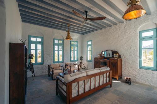阿波罗尼亚Eco-Luxe Retreat in Ano Petali, Sifnos的带沙发和吊扇的客厅
