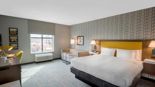 里弗赛德Hampton Inn Riverside Downtown的酒店客房设有一张大床和一张沙发。