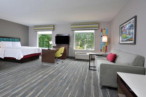 夏洛特Hampton Inn & Suites Charlotte North I 485的酒店客房,配有床和沙发