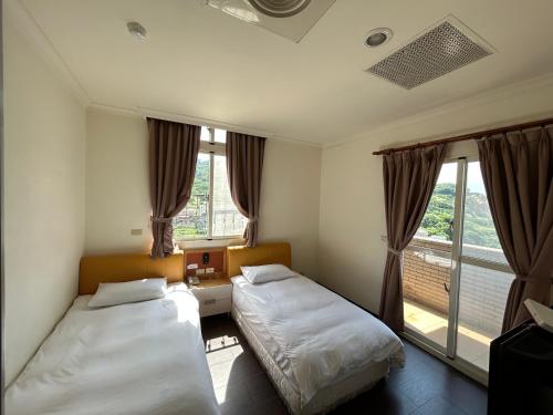 南竿富喜民宿二馆 的一间卧室设有两张床和窗户。