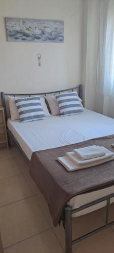 卡瓦拉Gavrihl home的一张带蓝色和白色枕头的床