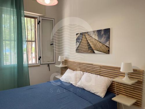 托雷拉皮罗Villa Aurora的一间卧室设有蓝色的床和窗户。