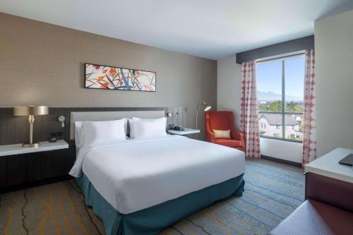 波莫纳Hilton Garden Inn Pomona, CA的一间设有大床和窗户的酒店客房