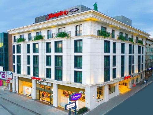 伊斯坦布尔Hampton By Hilton Istanbul Old City的白色的建筑,上面有标志