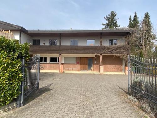 Kehrsatz绿叶郊区公寓的一座大型砖砌建筑,前面有门