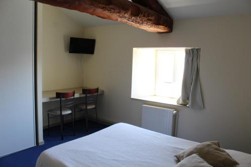 Talizat普拉尼耶旅馆的一间卧室配有一张床、一张书桌和一个窗户。
