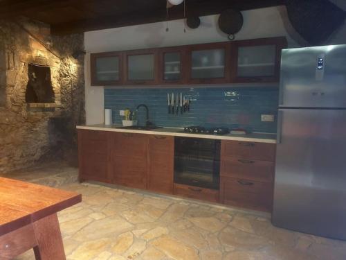 马里伊兹Beautiful rustikal Stone House的厨房配有木制橱柜和不锈钢冰箱。