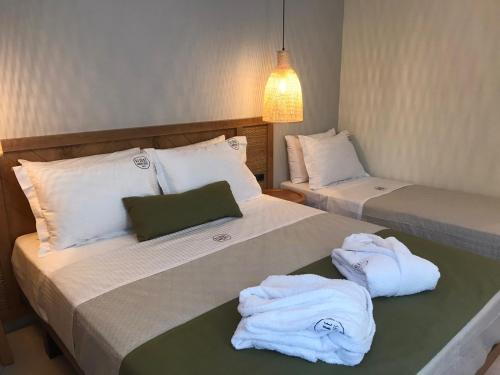波托什Azzure Luxury Suites的客房内的两张床和毛巾