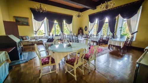托伊拉梅雷塔勒别墅酒店的用餐室设有桌椅和窗户。
