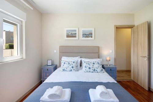 ArcozeloPontes Guest House的一间卧室配有一张床,上面有两条毛巾