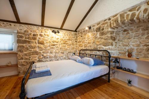 扎达尔Kuća za odmor Nikola的卧室配有一张石墙床