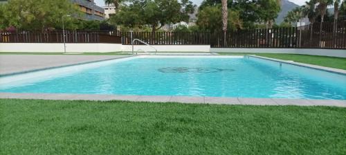 贝尼卡西姆Residencial El Trenet 2C的庭院里的一个蓝色海水游泳池