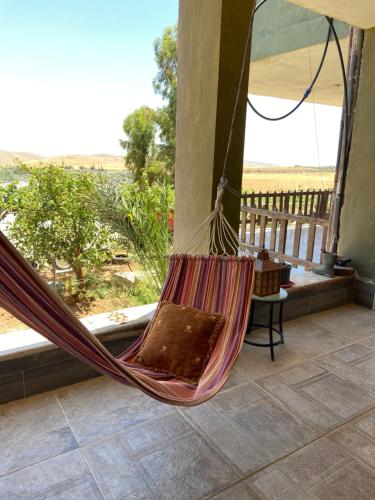 马达巴Simple home的享有沙漠景致的门廊上的吊床