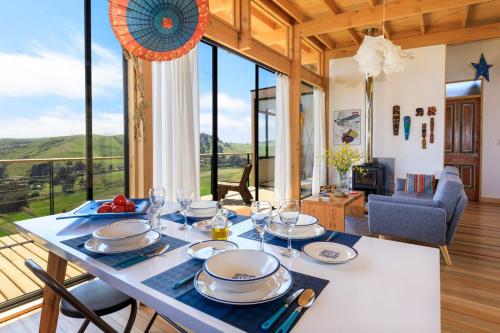马坦萨斯Lodge Alas de Matanzas的用餐室配有带盘子和玻璃杯的桌子
