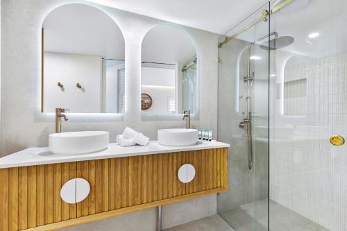 努萨角诺萨蓝色度假酒店的一间带两个盥洗盆和淋浴的浴室