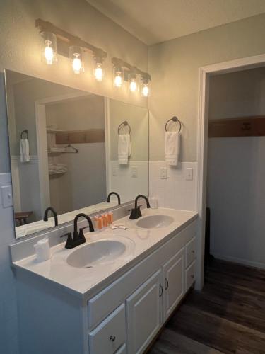 MarcelineHotel Marceline的一间带两个盥洗盆和大镜子的浴室