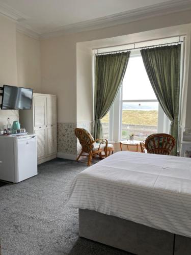 巴茅思Seascape的一间卧室设有一张床和一个大窗户