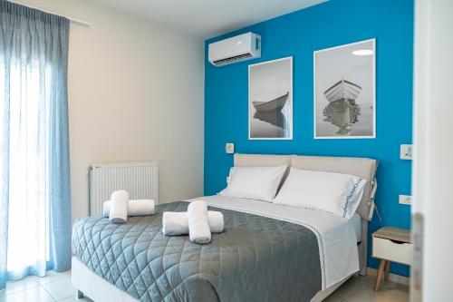 马斯蒂查里Villa Eos Mastichari - with heated pool的蓝色卧室配有带白色枕头的床