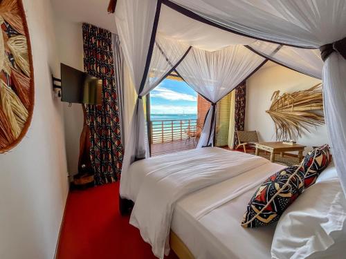 贝岛Maison Ylang Dive Center的一间卧室设有一张床,享有海景