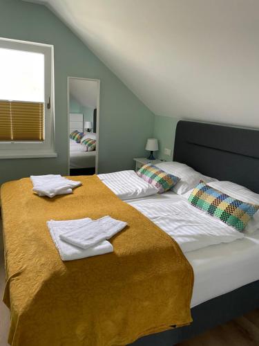法克湖克雷比席勒公寓的一间卧室配有两张带毛巾的床
