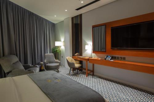 艾卜哈STwin Hotel的配有一张床和一台平面电视的酒店客房