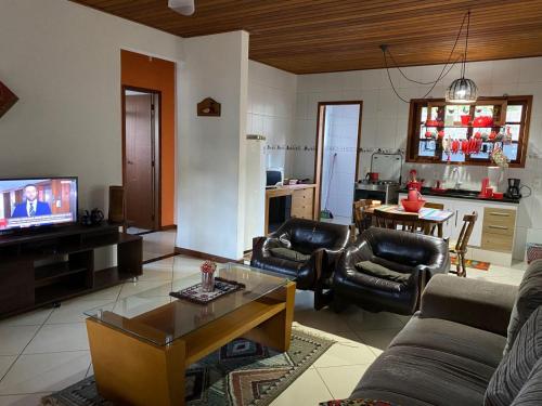 卢米亚Lumiar centro com Wi-FI aconchegante apartamento com 2 quartos mobiliado com ventiladores的带沙发、桌子和电视的客厅