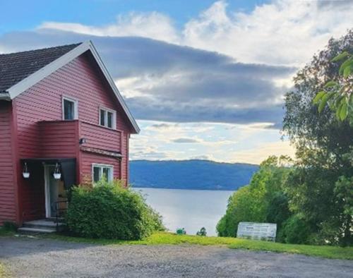 GranRandsfjord house的红色的湖景房屋