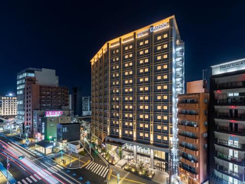 福冈Nishitetsu Hotel Croom Hakata Gion Kushida Shrine的城市的一座有灯光的建筑