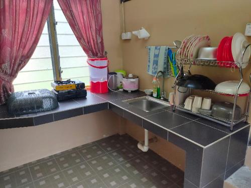 丹戎马林NUR RAMADHAN CAMPSITE的厨房配有水槽和台面