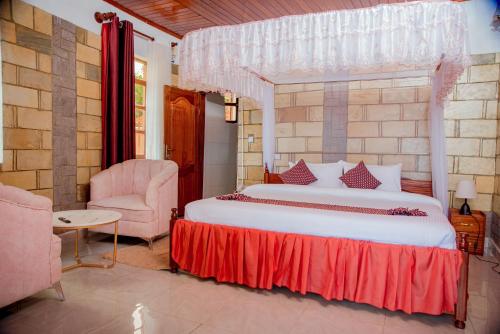 吉塞尼KIGUFI HILL, Agape Resort & Kivu Edge的一间卧室配有一张大床和一把椅子