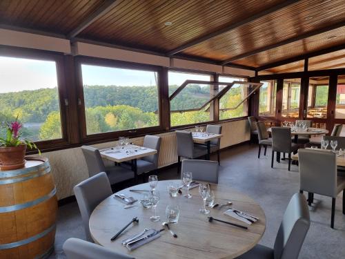拉卡佩勒－维耶斯康湖泊酒店的餐厅设有桌椅和窗户。