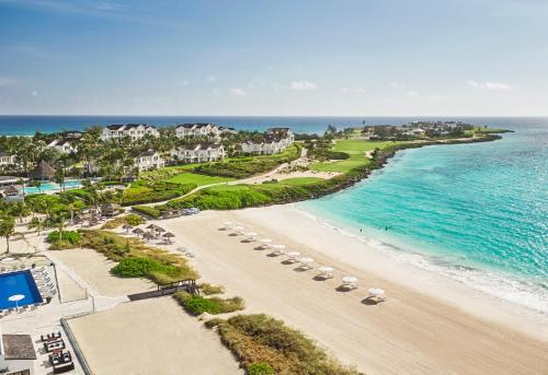 Farmerʼs HillGrand Isle Resort & Residences的享有海滩的空中景致,配有椅子和海洋
