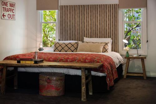 戴尔斯福特海滩小屋度假屋的一间卧室配有一张大床和木桌
