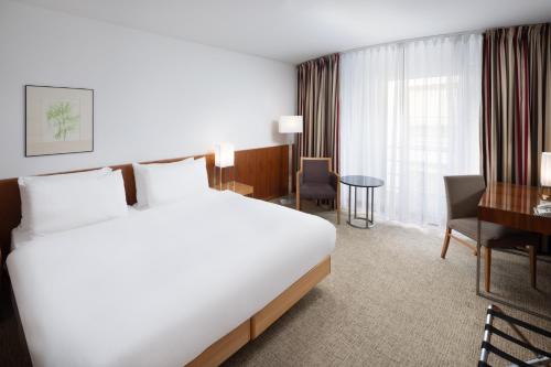 布达佩斯奥普拉K+K酒店的酒店客房设有一张大床和一张书桌。