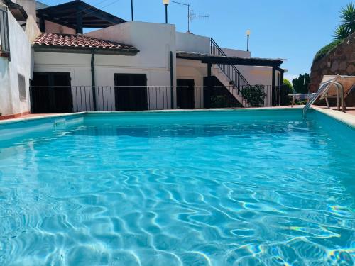 康培斯Villa Isolella的一座大蓝色游泳池,位于房子前
