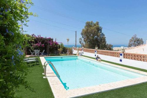 卡莱塔德贝莱斯Caleta del Sol con piscina terraza y playa的一座房子的院子内的游泳池