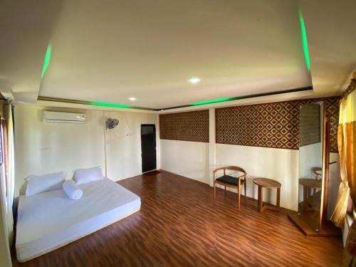 卡里蒙贾瓦Laendra Sunset Beach的卧室配有1张床、1张桌子和1把椅子