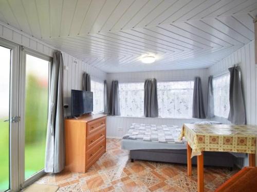 梅尔诺Domek Holenderski的卧室配有床、桌子和窗户。