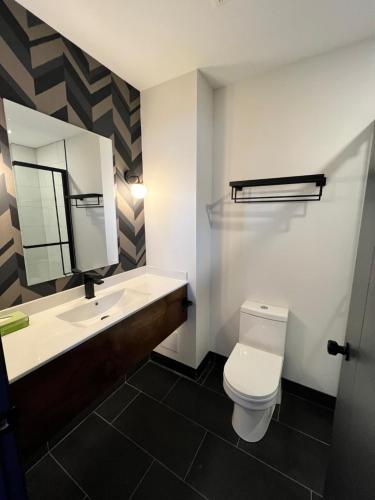 Little CurrentManitoulin Motel的一间带卫生间、水槽和镜子的浴室